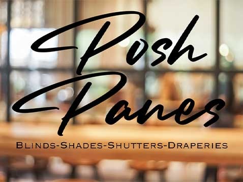 A blurred photo of a window with the caption "Posh Panes. Blinds-Shades-Shutters-Draperies"